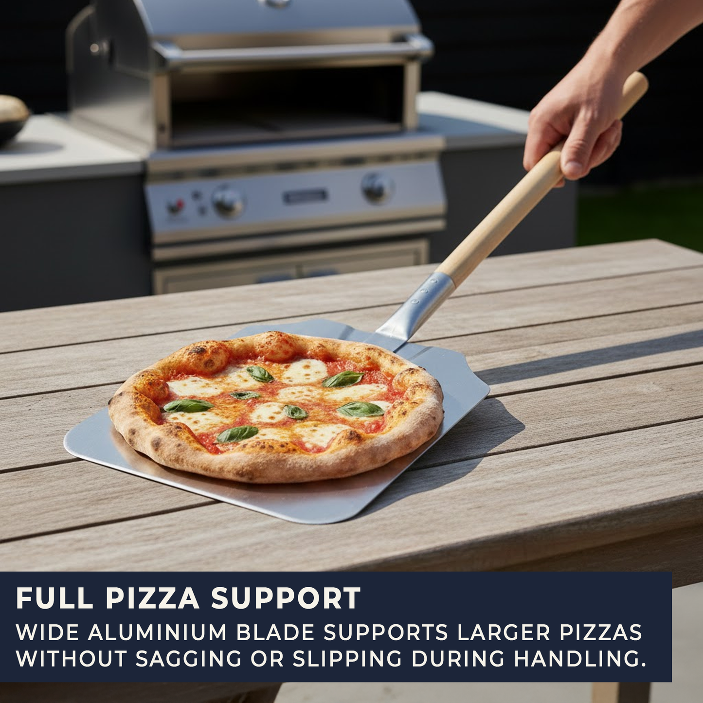 Angled view of large aluminium pizza paddle with long wooden handle
