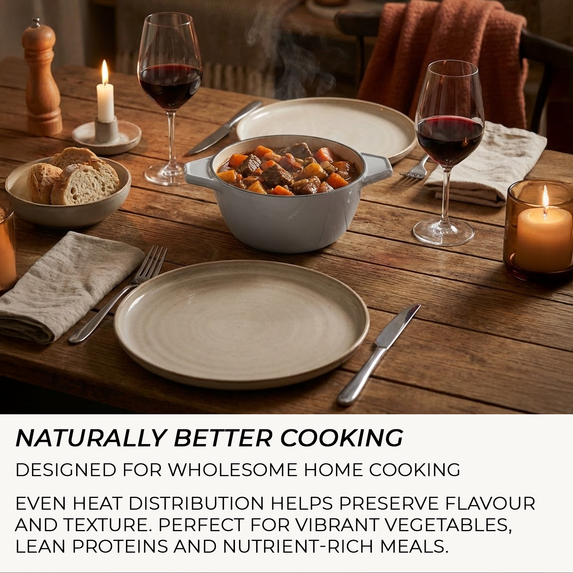 Dinner table set with a bowl of stew, bread, wine glasses, and candles on a wooden surface.