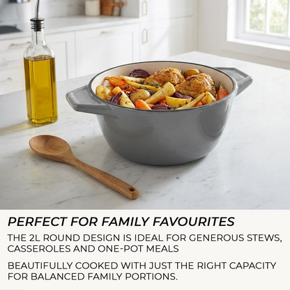 Gray casserole dish with roasted vegetables on a marble countertop, with text about its use for family meals.