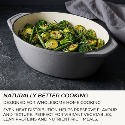 White ceramic dish with roasted vegetables on a dark surface, featuring text about cooking.