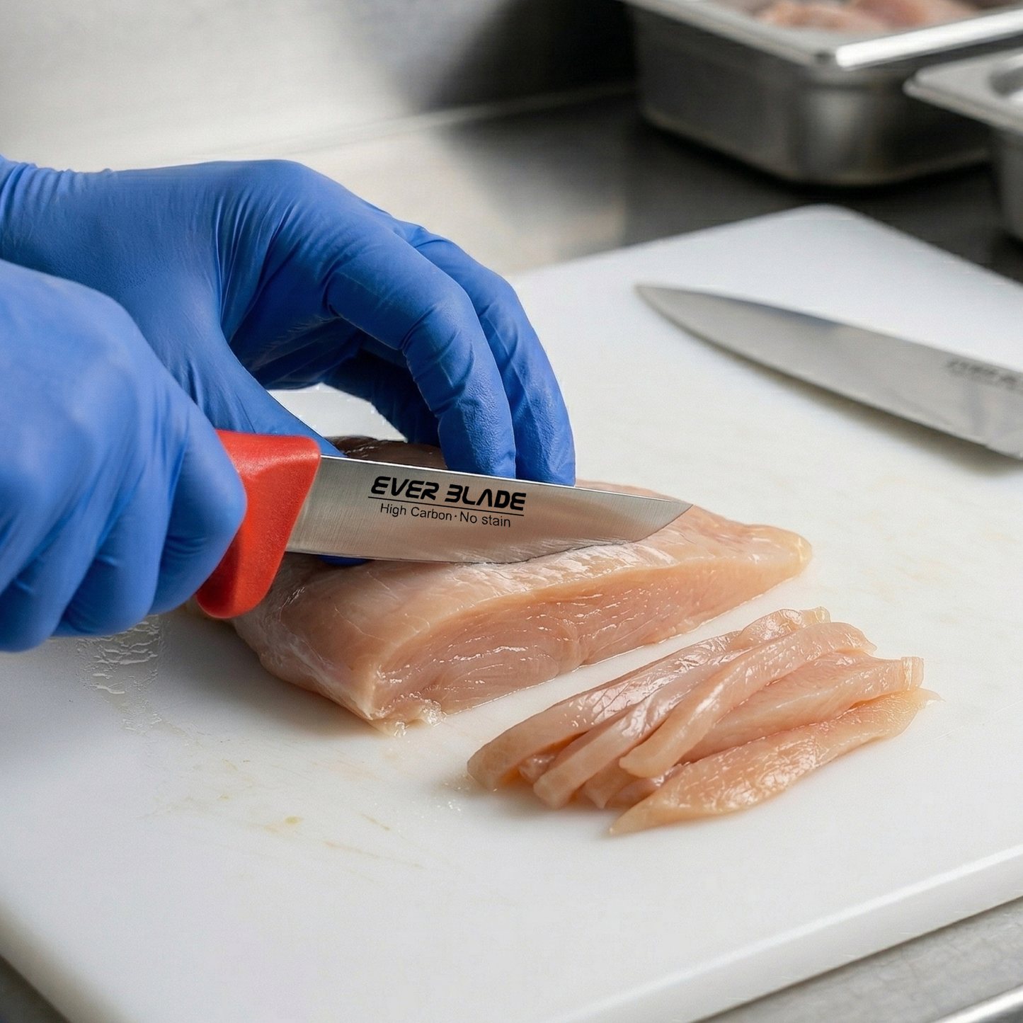 Person cutting chicken with a Ever Blade knife on a white cutting board.