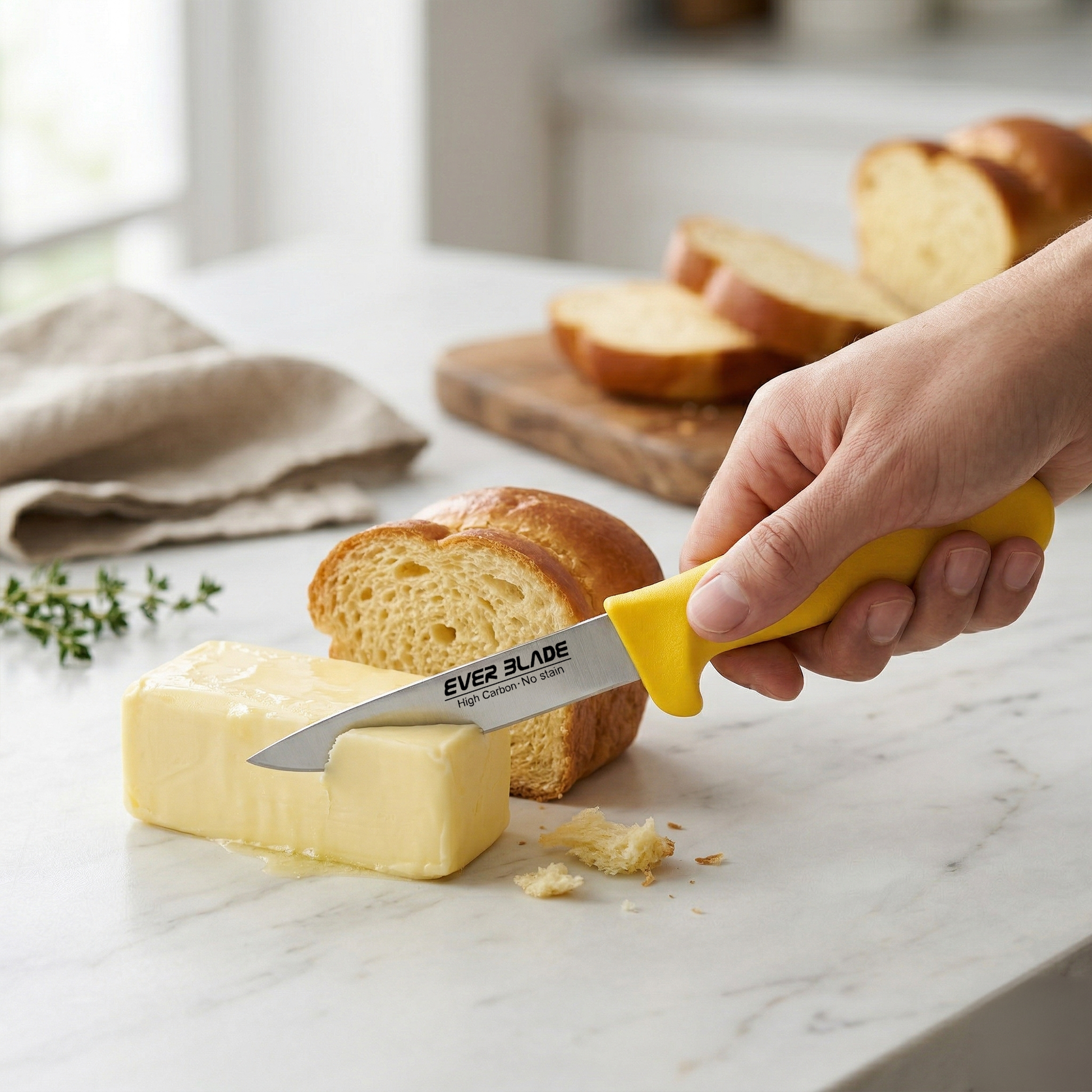 Person spreading butter on bread using a yellow-handled knife with 'EVER BLADE' branding.