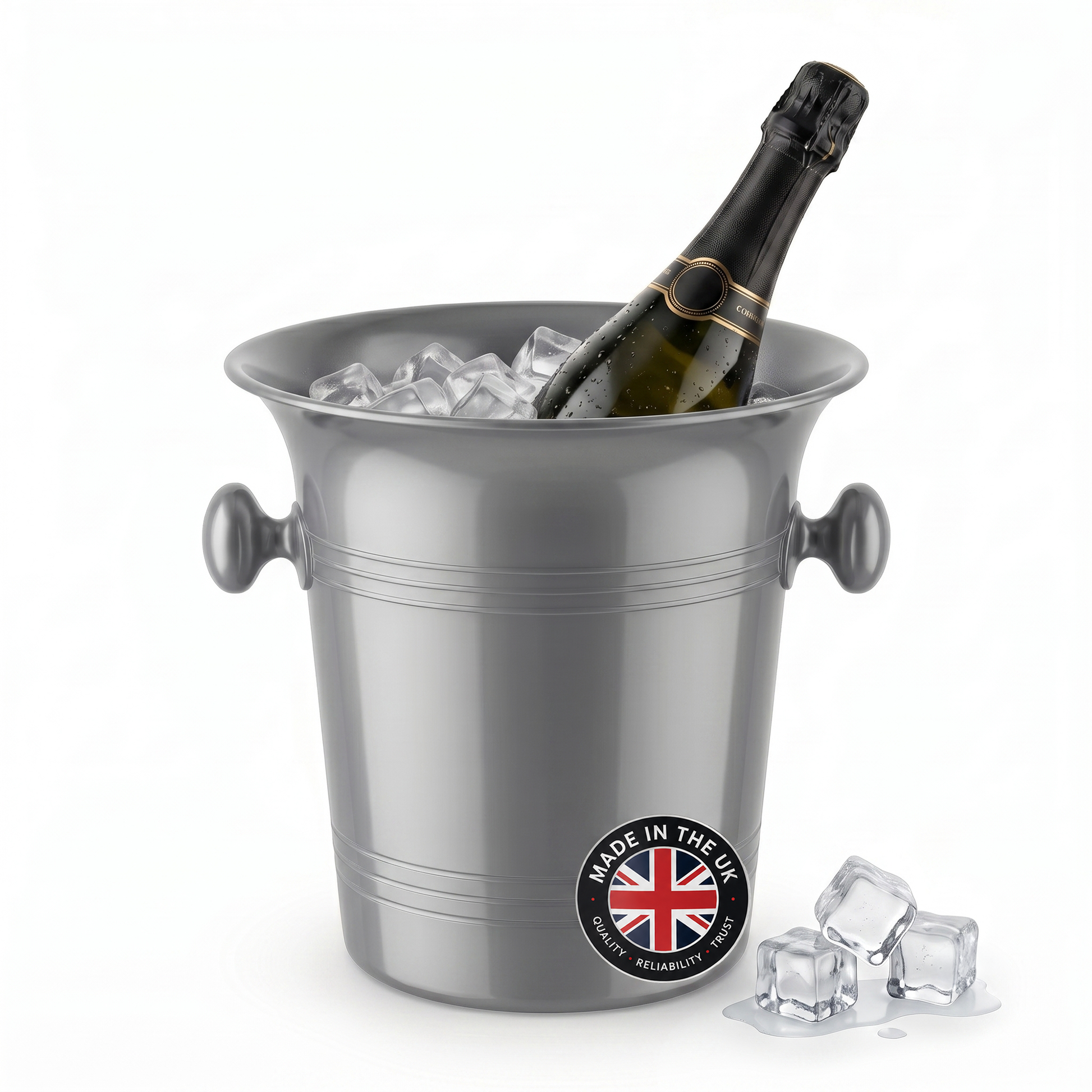 A silver metal champagne bucket filled with ice cubes, with a dark champagne bottle placed inside. The bucket has side handles and a round 'Made in the UK' badge near the bottom front.