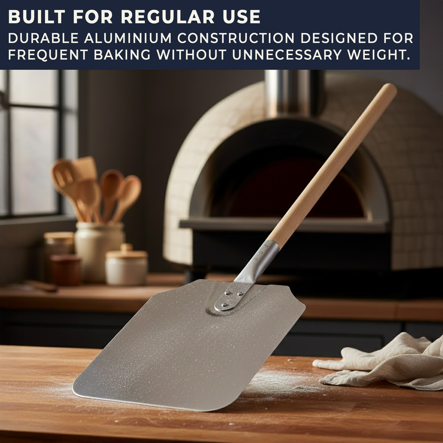 Durable aluminium pizza paddle resting on worktop showing quality construction