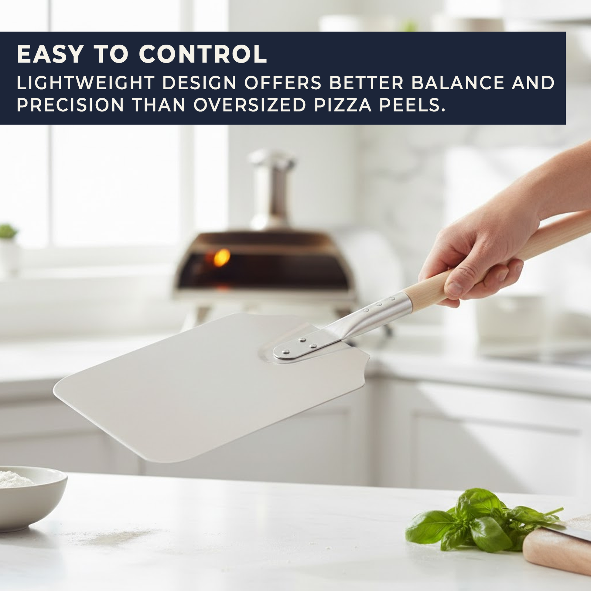 Aluminium pizza peel held in hand showing compact size and long wooden handle for control